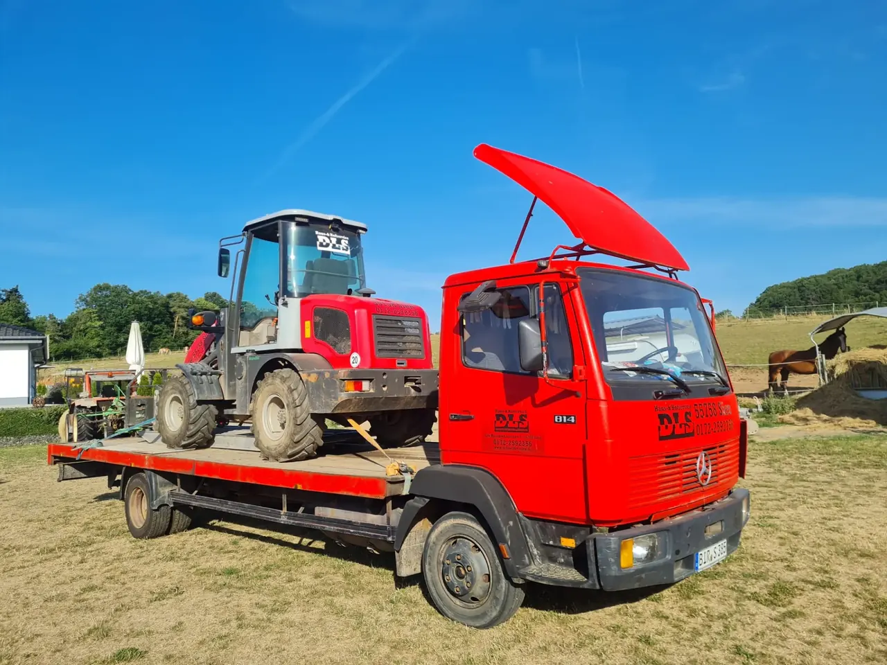 Transporter mit Radlader auf der Ladefläche im Einsatz